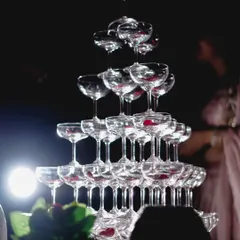 A classic shot of a champagne tower, a symbol of celebration at engagement and reception parties.