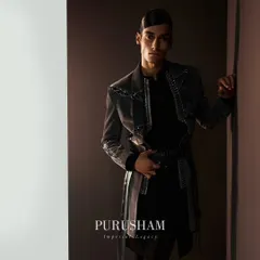 Eternal elegance triumphs. This grey jacket with a unique belted detail and metallic embellishments is a prime example of the rich, layered textures I explore in my winter collections.