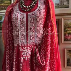 A full view of the Sindoori Red Anarkali, displaying the heavily embellished yoke and the graceful flow of the embroidered fabric. The ensemble is a perfect choice for weddings and grand celebrations.