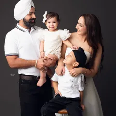 So much love and happiness in one frame. This family portrait is full of interaction and smiles, showing the beautiful bond between parents and their two children.
