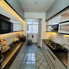 A look at a completed parallel kitchen in Amrapali Princly Estate. I focused on maximizing counter space and storage, using under cabinet LED lighting to create a bright and functional cooking environment.