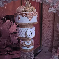 Another one of my chandelier cakes, this time with white and rose gold details, including a quilted middle tier and crystal hangings.
