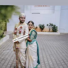 The happy couple, Akshitha and Pramod, in their custom designed wedding attire. The bride's blouse perfectly complements the groom's sherwani.