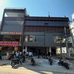 The exterior of the "Vrindavana Kalyana Mantapa," a marriage convention hall we designed. The contemporary facade with glass and dark panels makes it a standout landmark in the town.