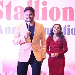 Sharing a laugh with a co-host on stage. My ability to build instant rapport with others ensures a smooth and entertaining show, whether I am hosting solo or as part of a team.