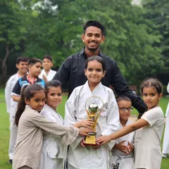 This trophy isn't just metal, it's proof of our collective hard work. I am incredibly proud of my young fighters who hold it high. We win as a family.