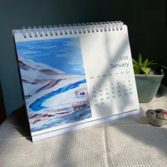 A glimpse of the January page from my 2023 desk calendar. It features a watercolor painting of a snowy landscape with a bright blue river, setting a peaceful and hopeful tone for the start of the year.