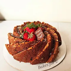 A whole wheat date, walnut, and carrot Bundt cake. I've added a simple chocolate drizzle and fresh strawberries to complement the rich, earthy flavors of the cake.