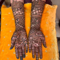This engagement design features classic peacock tops and a traditional jaal (net) pattern on the arms.