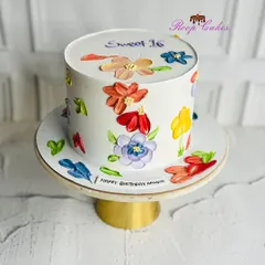 A floral dream for a sweet 16. This elegant cake is covered in colorful, hand-painted blooms using a palette knife technique, making it a true work of art.