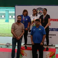 With the medalists on the podium. My experience as an ISSF Judge ensures that our academy's training and competitions are conducted with the utmost professionalism.