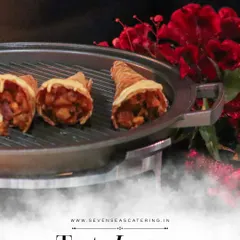 Cones of creativity, filled with flavour and flair. These savoury cones are presented on a grill-style platter, adding a touch of drama to their service.