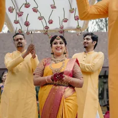 The bride's grand entrance, escorted by her brothers under a custom floral canopy. This is a moment filled with family love and tradition, and we ensure it's as beautiful as she dreamed.