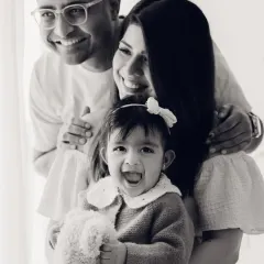 A classic family portrait in black and white, full of smiles. This timeless style is perfect for creating heirloom images.