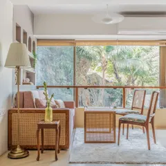 This space was designed to be multifunctional. It serves as a calm nutrition clinic by day and easily transforms into a cozy bedroom by night, with large windows that bring in the beautiful greenery from outside.