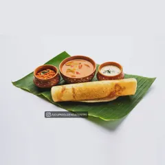 A simple and classic plain dosa served with sambar and two kinds of chutney in earthen bowls. This showcases the authentic flavors of our Udupi-style catering.