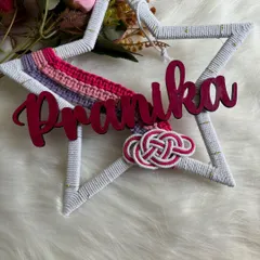 A star-shaped name hanging for Pranika, featuring a mini rainbow and a Celtic knot detail. This design is perfect for adding a touch of magic and personalization to a nursery or bedroom wall.