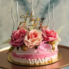 A beautiful floral birthday cake with a rustic, textured buttercream finish. The fresh roses and custom name make it a personal and elegant choice.