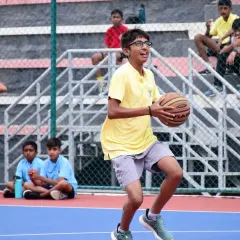 A player looks for an open teammate, demonstrating the court awareness and teamwork we emphasize in our basketball program.