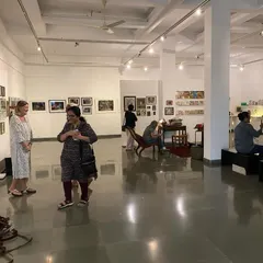 A wide view of the 'Southern Stars' exhibition, showing the recreated living room setup in the center of the gallery. This curatorial choice invited visitors to feel at home among the cinematic memorabilia.