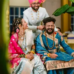 The playful 'kaan pili' ritual, where the bride's brother playfully twists the groom's ear, brings a moment of laughter and fun to the solemn ceremony.
