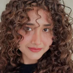 These curls don't follow rules, they make them. A close-up shot of beautifully defined, colored curls.
