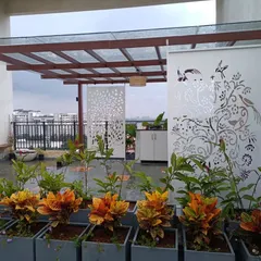 For this project at Adarsh Palm Retreat Villas, we added custom laser-cut jaali screens to a glass pergola. These screens provide privacy and add a unique artistic element to the outdoor space.