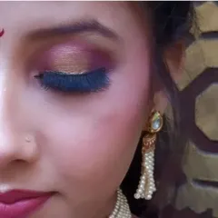 A close-up of a beautiful pink and gold glitter eye makeup look, perfect for festive occasions.