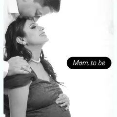 A sweet black and white close-up of a partner embracing the "Mom to be" from behind, capturing a moment of pure happiness and anticipation.