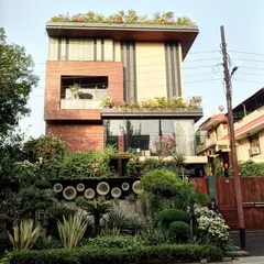 A full view of a modern villa in Noida where I designed and installed integrated greenery on the ground floor, balconies, and a full rooftop garden.