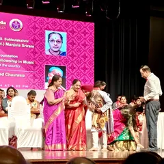 Receiving the award on stage. A moment of immense pride and humility, bowing in respect for the honor.