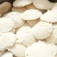 A large batch of mini idlis prepared for a housewarming function. We can cater to large orders, ensuring every single idli is soft and delicious.
