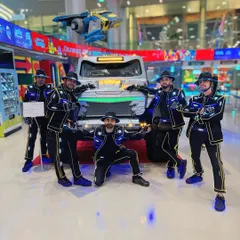 Posing with a futuristic vehicle at an event in Doha. Our costumes fit right in with the high-tech atmosphere of the city.