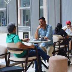 A casual business meeting happening at our RMZ cafe. The space is yours for catching up, jumping into meetings, or just grabbing a quiet coffee.