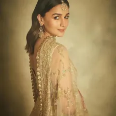 Another angle of Alia Bhatt's graceful look, highlighting the intricate details on the back of her outfit and how the gold jewellery catches the light.