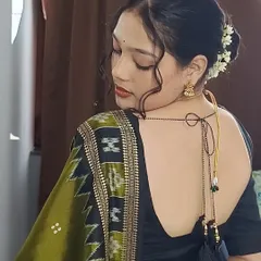 Details matter. This close-up shows how the drape complements the deep-back blouse and traditional hairstyle with flowers. I help style the entire look to ensure every element is in harmony for a polished finish.