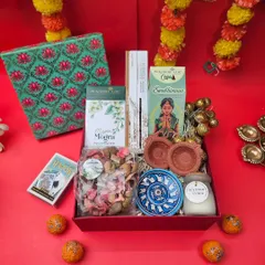 For those who appreciate tradition, this Indian culture hamper for Diwali is perfect. It includes diyas, a blue pottery dish, incense, potpourri, and laddus, all packed in a beautiful red box.