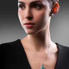 A classic portrait for Solitario Diamonds. The lighting is carefully controlled to highlight both the model's features and the sparkle of the emerald and diamond necklace set.