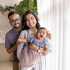A moment of pure, unrestrained joy from a little girl during her family photoshoot. It's these candid, happy screams and laughs that truly tell the story of childhood.