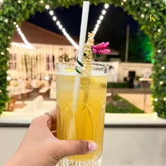 A guest holding a refreshing drink with a custom "More Bubbles" stirrer. It's these small, personalized details that elevate the experience and bring a smile to your guests' faces.