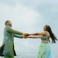 A moment of pure, uninhibited laughter during a beachside Haldi. The couple holds hands and spins, their joy infectious. This is the kind of authentic, happy moment I love to capture.