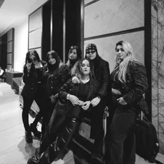 This is the squad. Sunshine mixed with a little hurricane. Backstage before a show, this black and white shot captures the bond and the fierce energy of the talented women who make up Womaniya.
