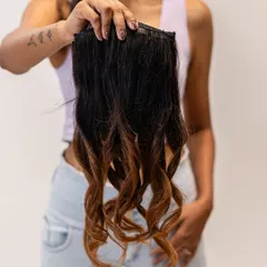 This ombre clip-in extension set is perfect for adding a touch of color and dimension. The seamless transition from dark to light brown creates a beautiful, sun-kissed effect.
