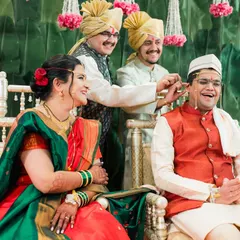 A fun, candid moment during the Kashi Yatra ritual in a Maharashtrian wedding, with family sharing a laugh with the groom.