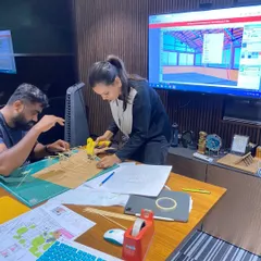 Collaboration is key. Here, my team and I are working on a physical model for the "Kaivalyam" yoga resort, figuring out the details of a complex truss system while referencing the digital model on screen.