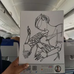 A pen sketch of a person playing a pizza-like drum, created on my sketchbook while traveling.