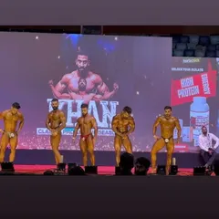 A lineup of champions at the Khan Classic. You can see the level of conditioning and muscle maturity my athletes bring to the stage. We train to stand out and make an impact from the moment the lights hit.