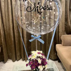 It's a boy! We customized this hot air balloon arrangement to welcome baby Moosa, using a mix of purple and white chrysanthemums and a personalized balloon with silver confetti and blue ribbons.