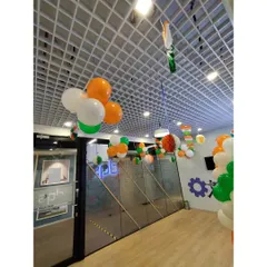Another view of the DQS office, showing how the hanging balloon decorations and paper crafts fill the common areas and hallways, creating a cohesive festive look throughout the space.