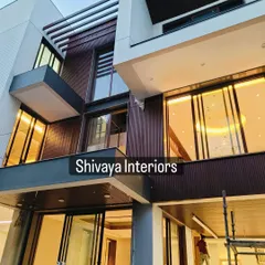 An evening view of a contemporary building where my team installed dark, vertically grooved cladding. The design was planned to maximize the effect of integrated lighting, giving the facade a dramatic and sophisticated look after sunset.